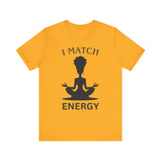 Yellow t-shirt with a black silhouette of a person in a meditative pose and text 'I MATCH ENERGY' on a white background.
