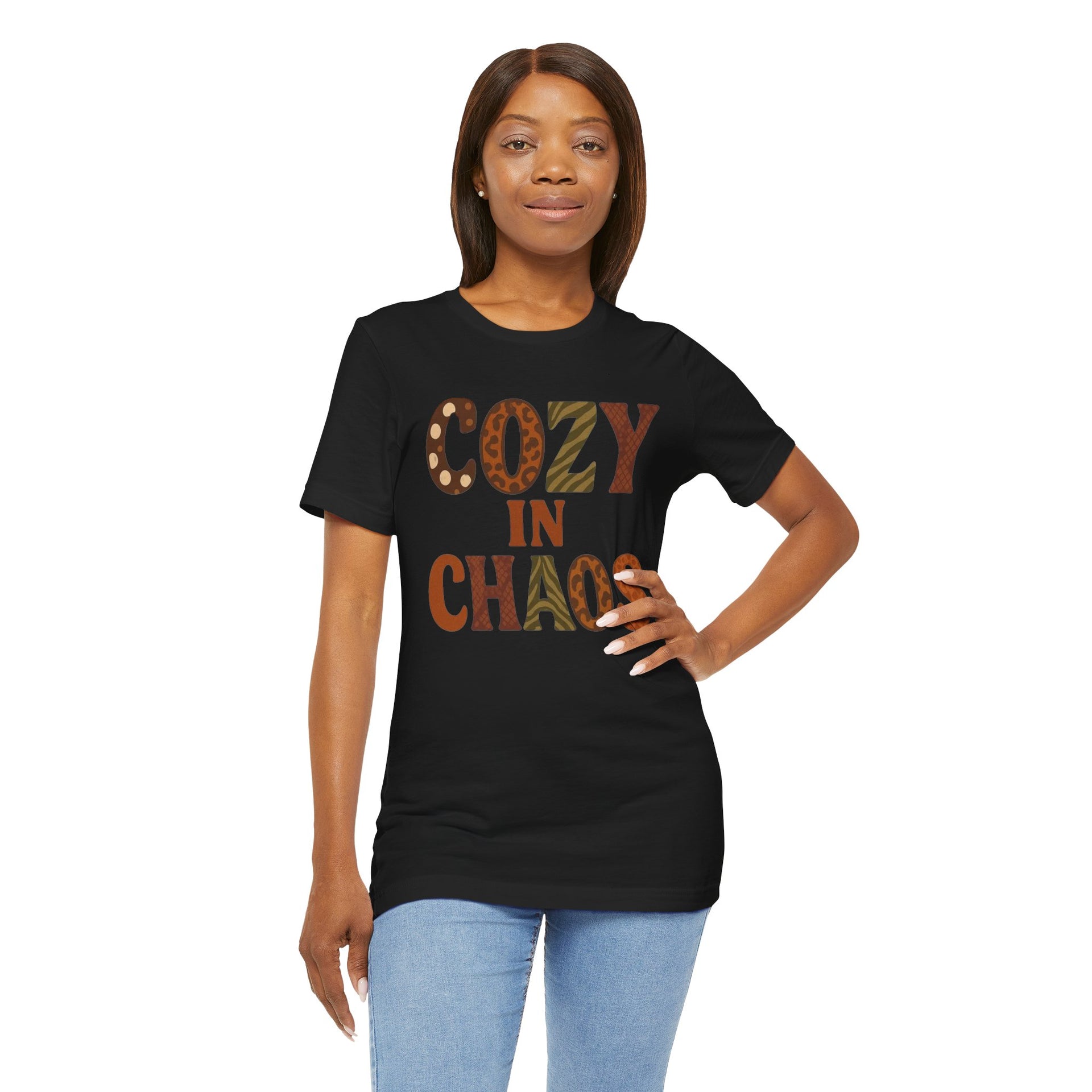 Woman wearing a black t-shirt with 'COZY IN CHAOS' text on a white background