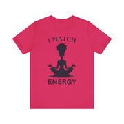 Pink t-shirt with a black silhouette of a person in a meditative pose and text 'I MATCH ENERGY' on a white background.