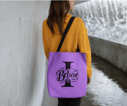 Woman wearing Believe in Me Tote Bag, purple design with black straps
