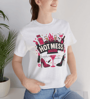 Person wearing a white t-shirt with a colorful graphic and text, standing against a light background.