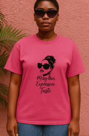 Person wearing a pink t-shirt with a graphic design and text against a pink background