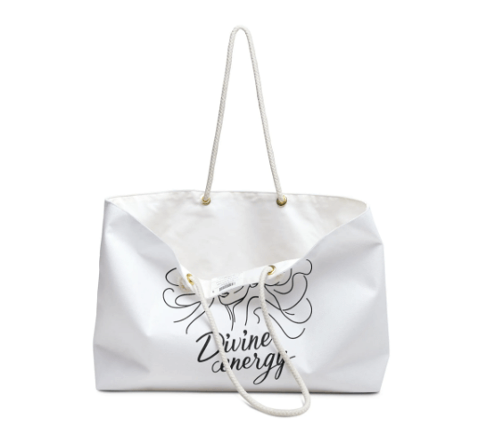 White tote bag with 'Divine energy' text on a white background