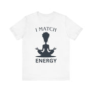 White t-shirt with a black silhouette of a person in a meditative pose and text 'I MATCH ENERGY' on a white background.