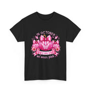 Black t-shirt with pink pumpkin design and 'In October we wear pink' text on a white background