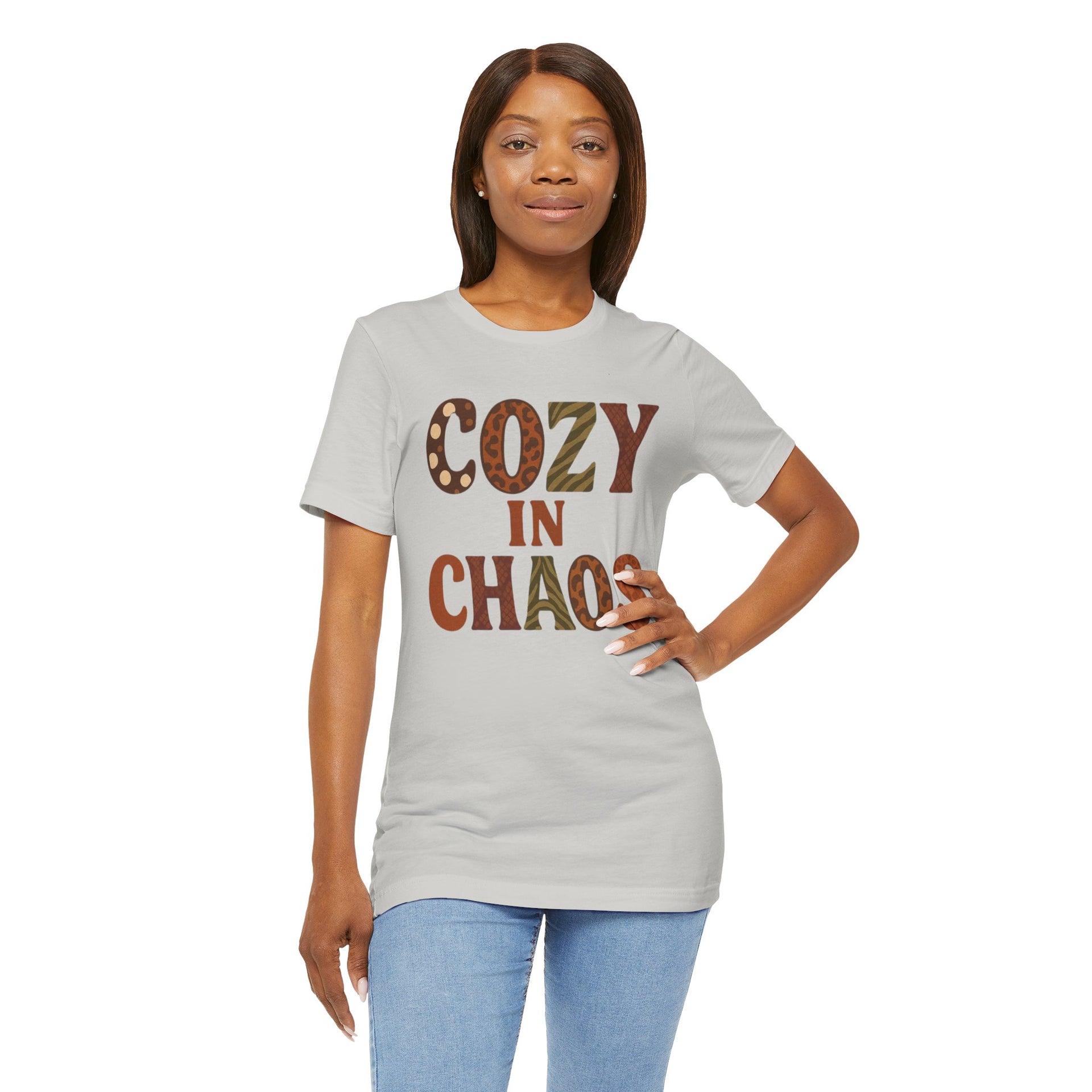 Woman wearing a gray t-shirt with 'COZY IN CHAOS' text on a white background