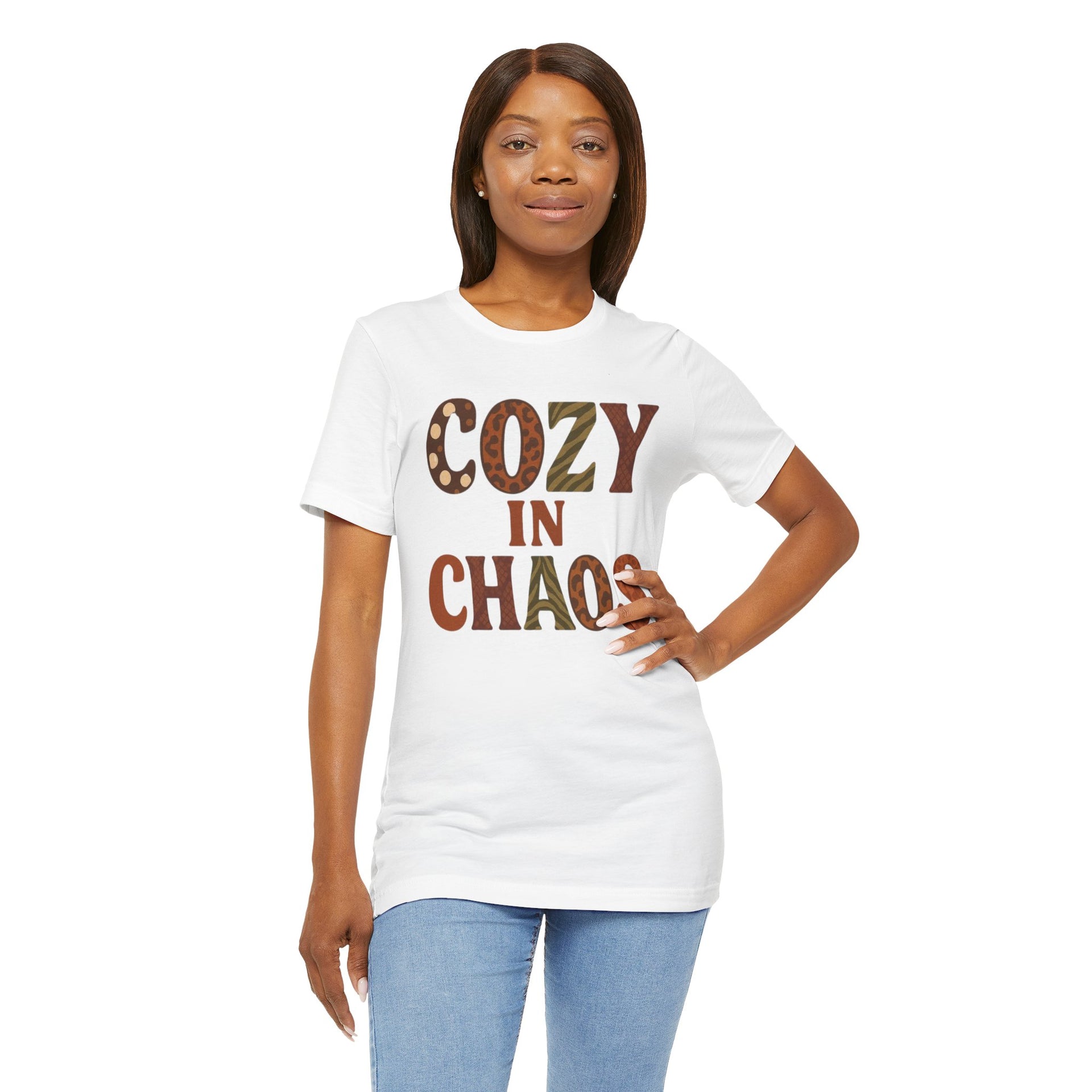 Woman wearing a white t-shirt with 'COZY IN CHAOS' text on a white background