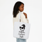 Woman holding a tote bag with a design and text on a white background