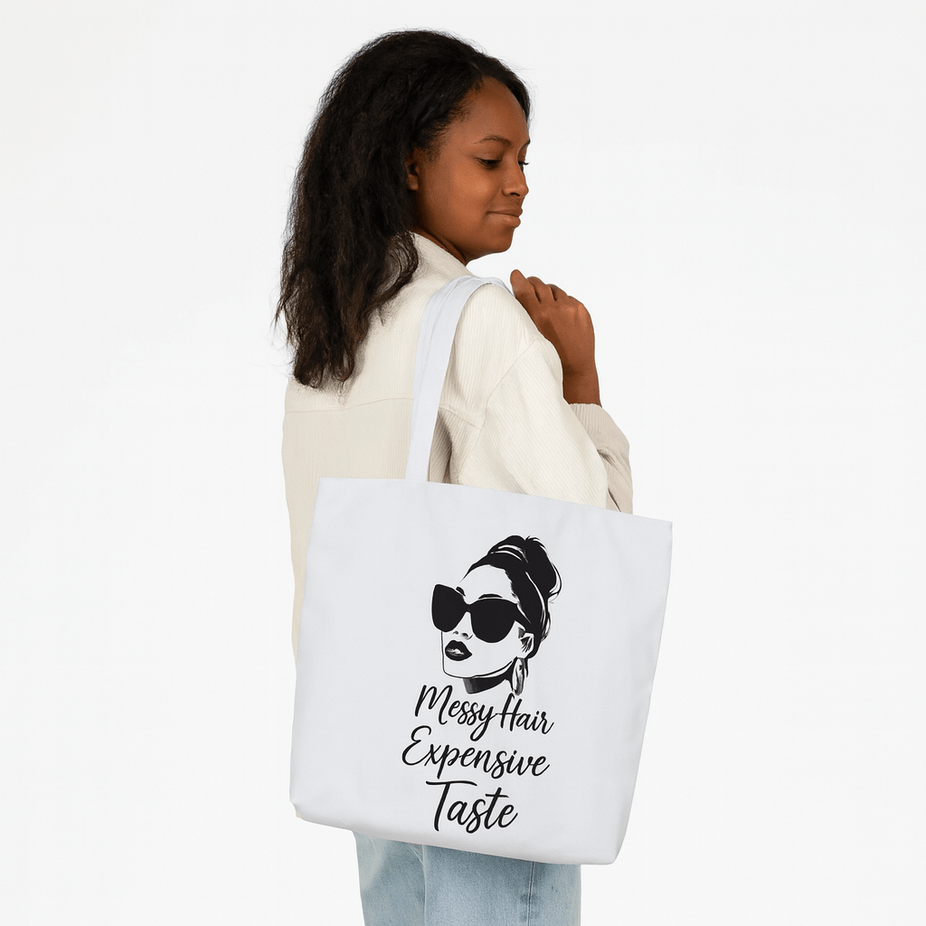 Woman holding a tote bag with a design and text on a white background
