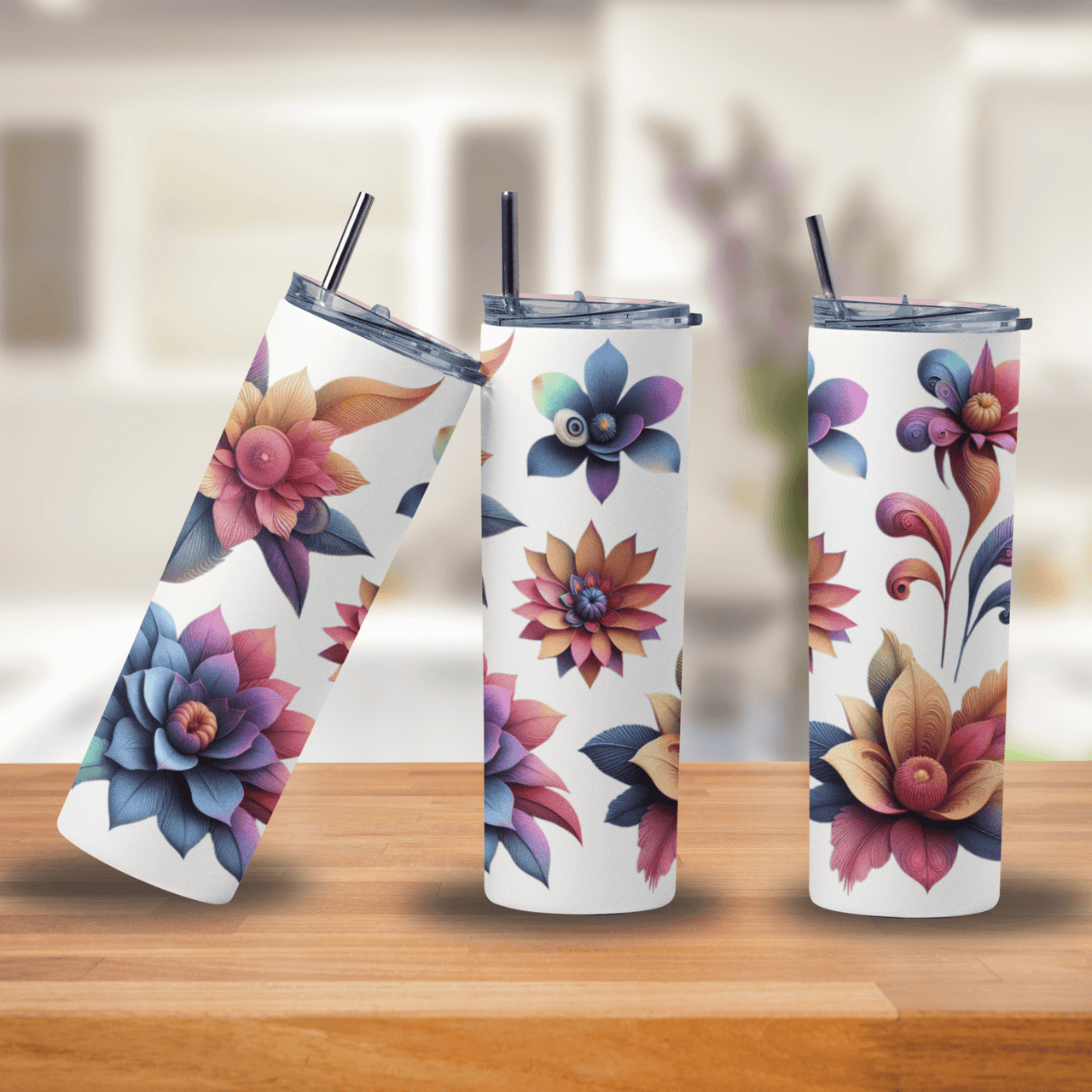 Three floral-patterned tumblers on a wooden surface with a blurred background