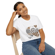 Woman wearing a white t-shirt with heart designs sitting on a chair.
