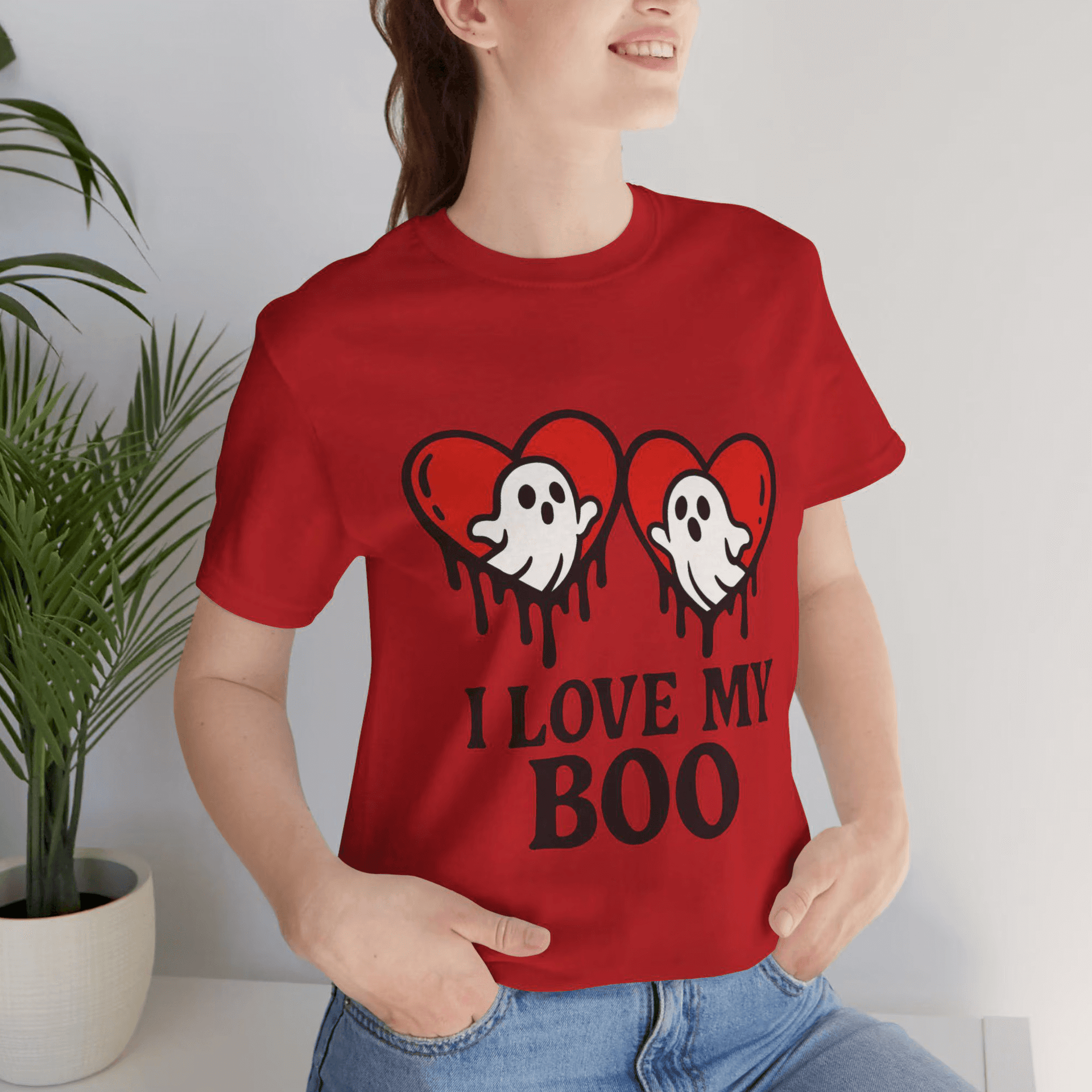 Person wearing a red t-shirt with 'I Love My Boo' design, standing indoors.