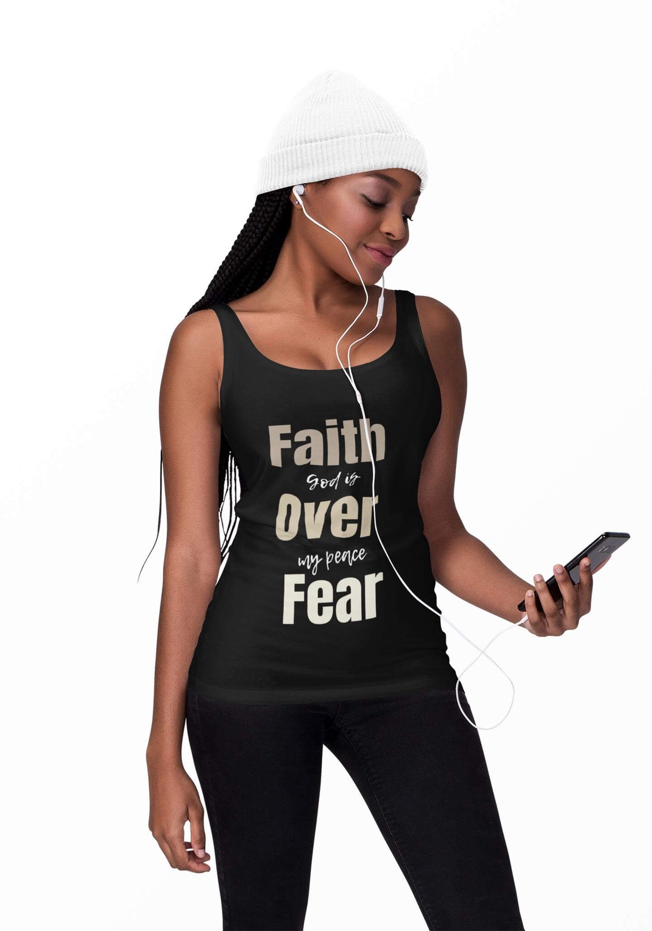 Woman wearing a black tank top with motivational text, listening to music on headphones.