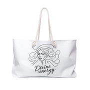 White tote bag with a black design of a woman's face and 'Divine energy' text on a white background