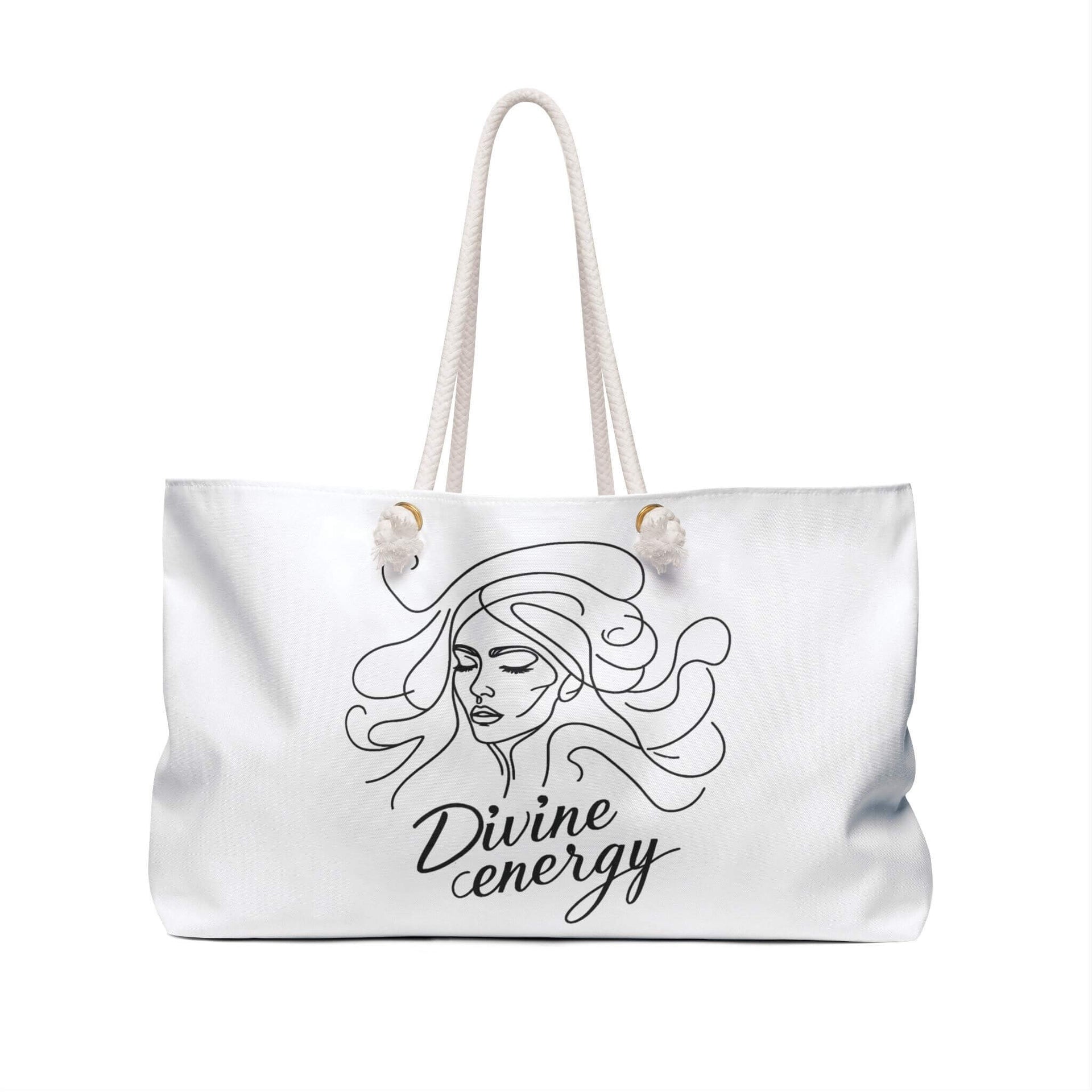 White tote bag with a black line drawing of a woman's face and 'Divine energy' text on a white background