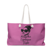 Pink tote bag with a graphic of a woman with sunglasses and text on a white background