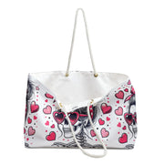 White tote bag with skull and heart design on a white background
