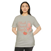 Woman wearing a gray t-shirt with 'Blush, Brunch, Repeat' text and graphics on a white background