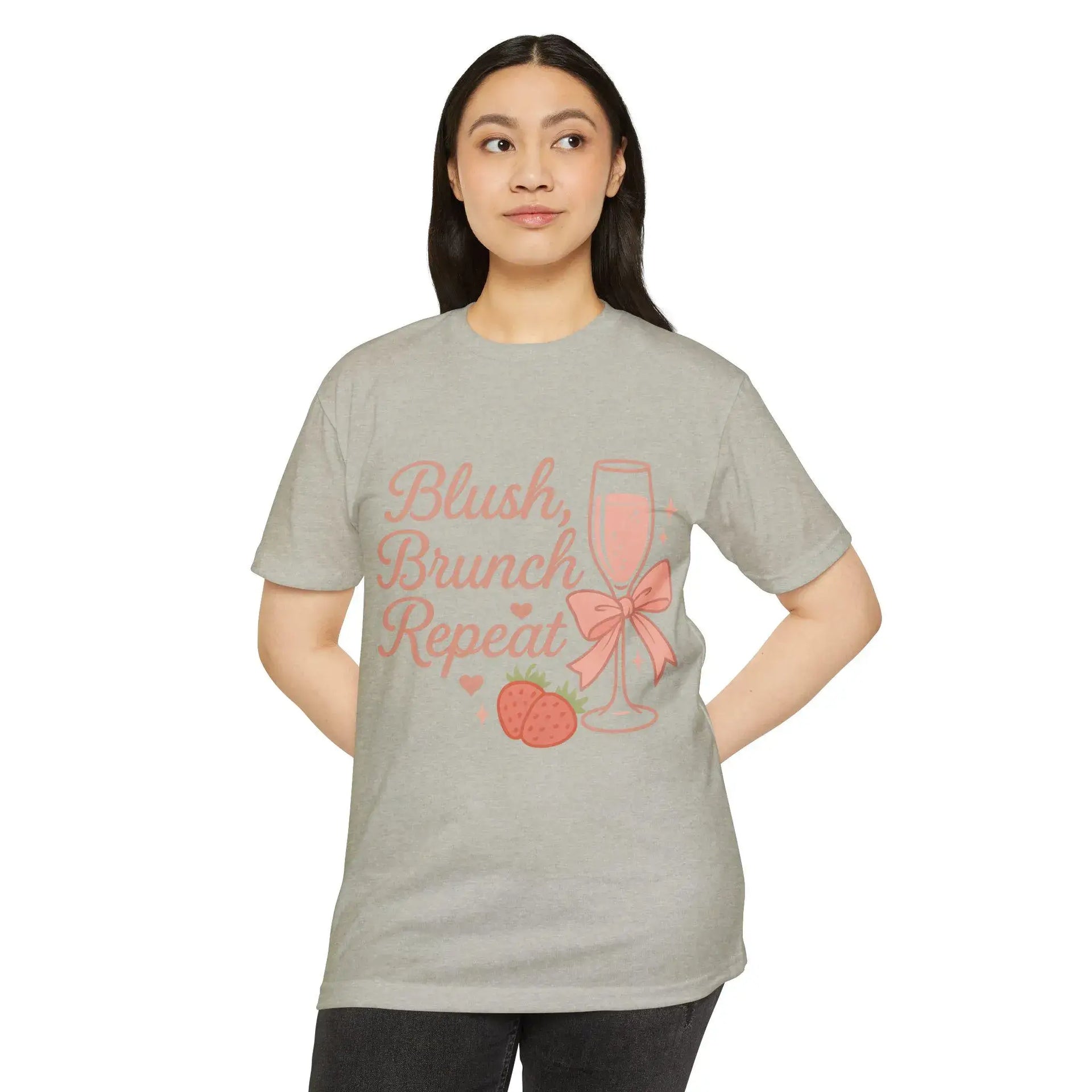 Woman wearing a gray t-shirt with 'Blush, Brunch, Repeat' text and graphics on a white background