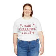 Person wearing a white t-shirt with 'MAIN CHARACTER CLUB' text and stars on a white background