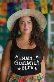 Woman wearing a black tank top with 'MAIN CHARACTER CLUB' text and a colorful hat in front of a vibrant background.