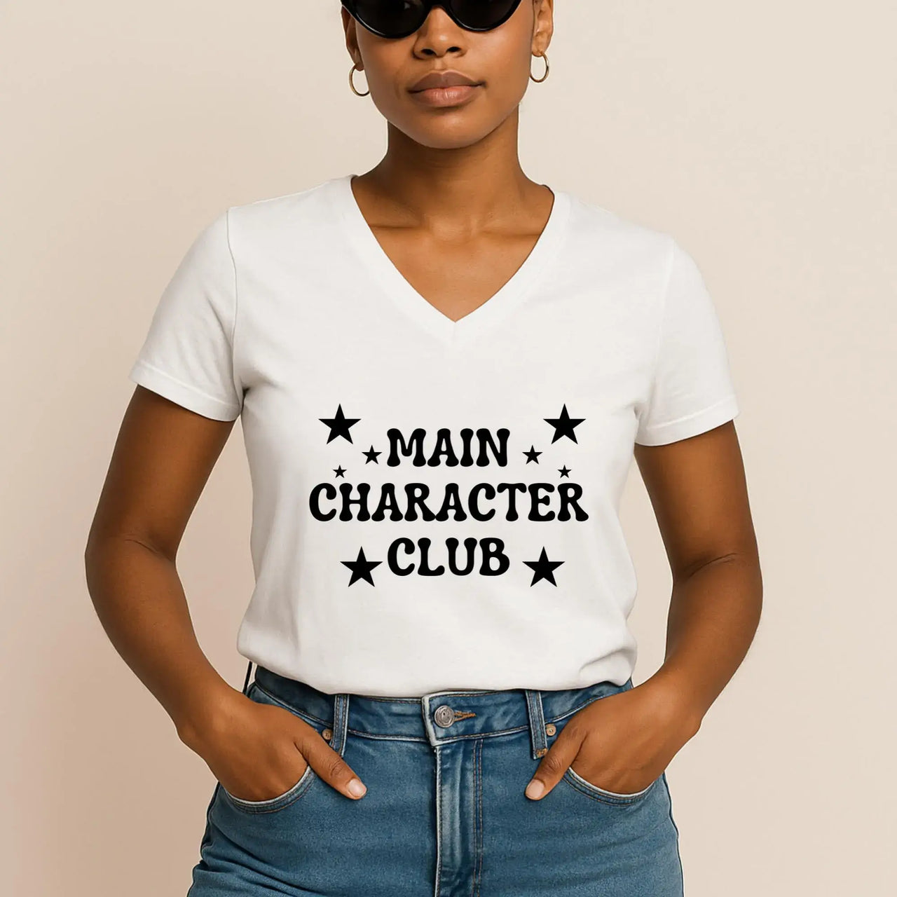 Person wearing a white t-shirt with 'MAIN CHARACTER CLUB' text on a beige background