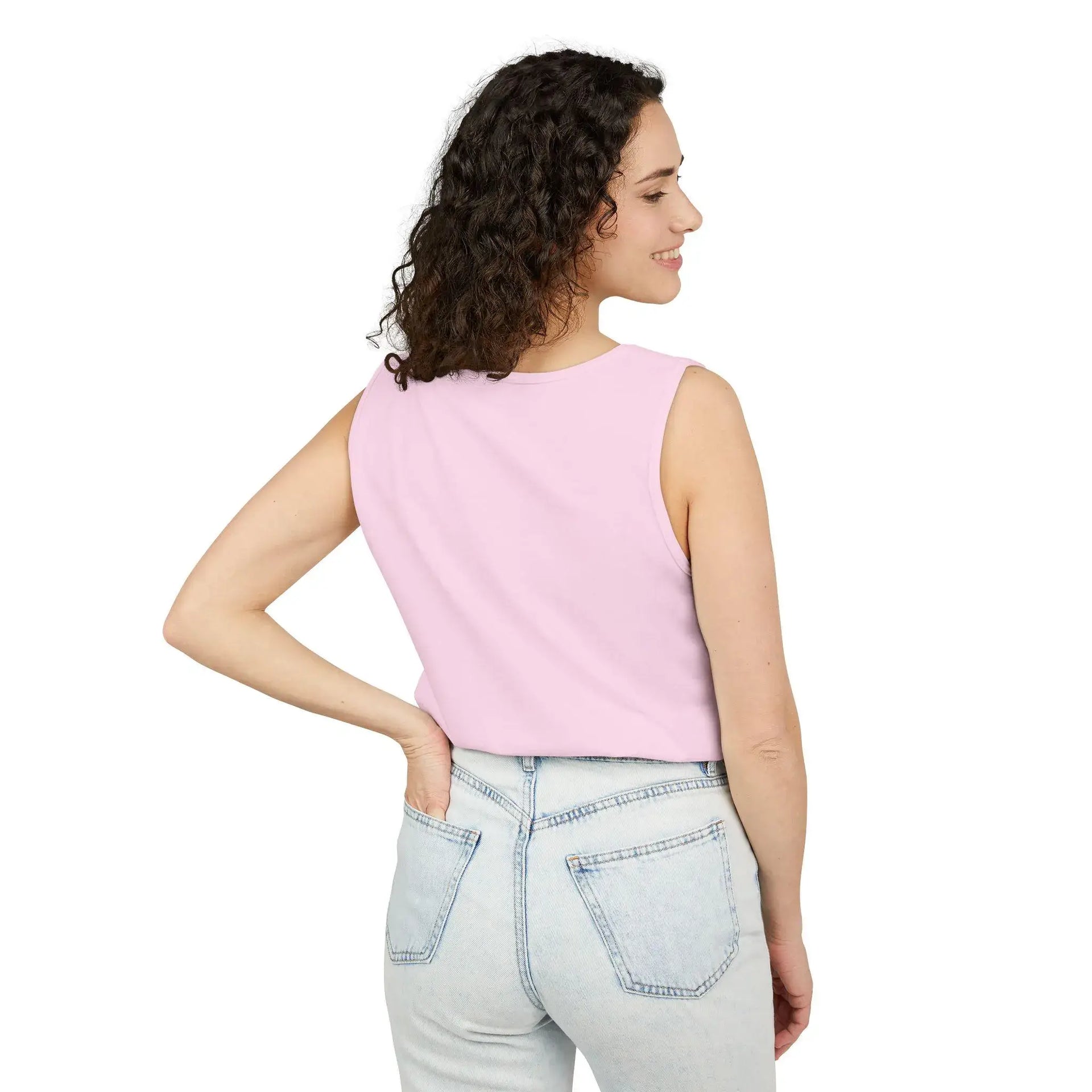 Woman wearing a pink sleeveless top and light blue jeans on a white background