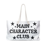 White tote bag with 'Main Character Club' text and star designs on a white background
