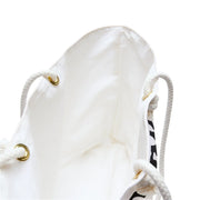White drawstring bag with gold eyelets and a visible brand logo on a white background