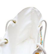 White drawstring bag with gold metal loops on a white background