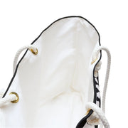 White drawstring bag with black accents on a white background