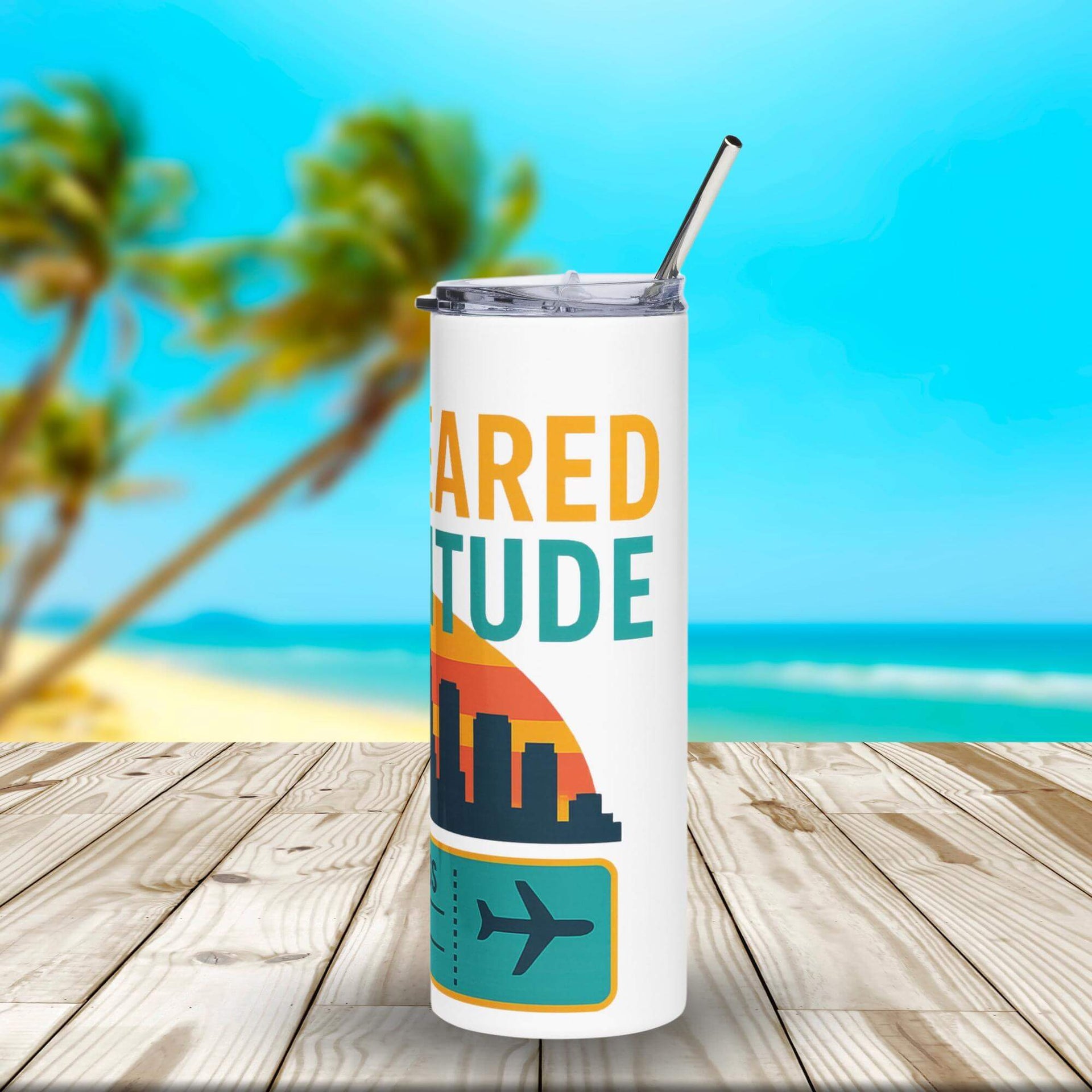 Tumbler with 'ARED TITUDE' design on a wooden surface with a beach background