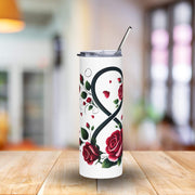 Tumbler with rose design on a wooden table