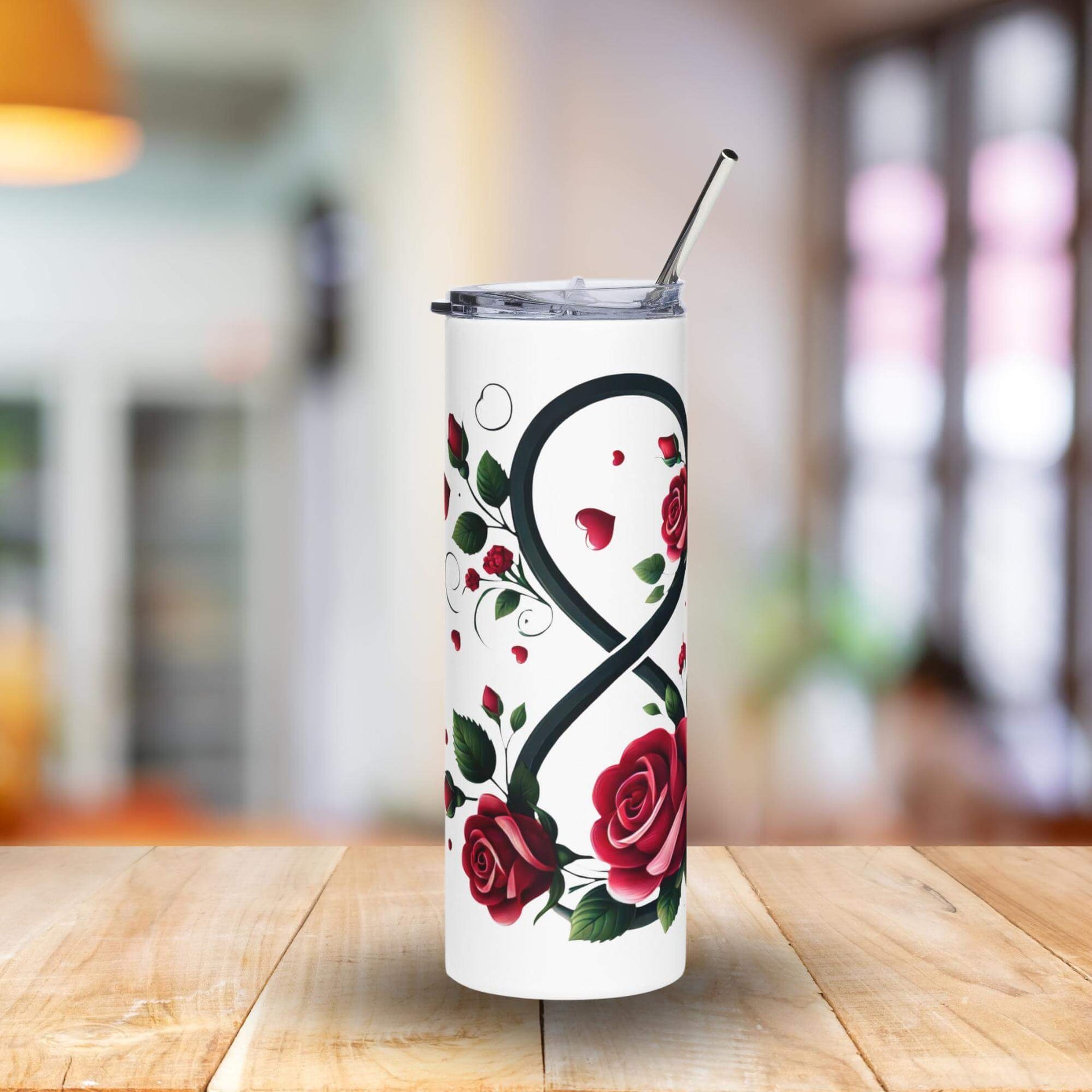 Tumbler with rose design on a wooden table