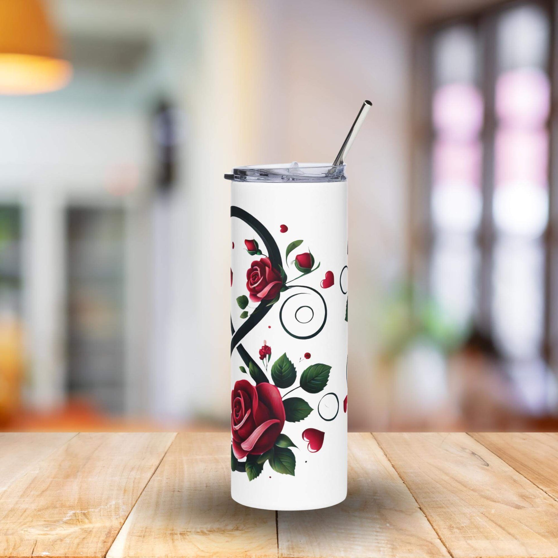 Tumbler with rose design on a wooden table