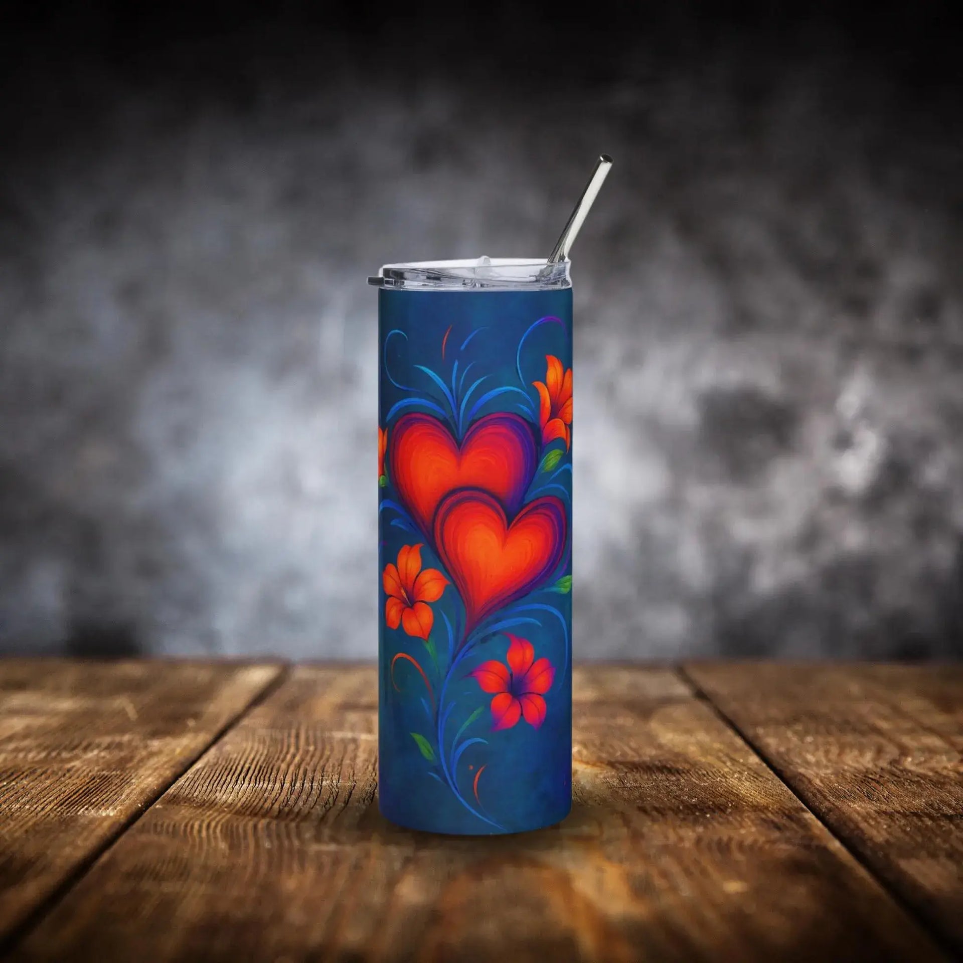 Tumbler with heart and floral design on a wooden surface