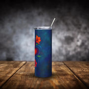 Colorful tumbler with floral design on a wooden surface and dark background