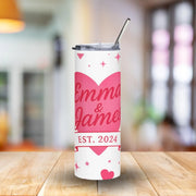Personalized tumbler with 'Emma & James EST. 2024' design on a wooden table.