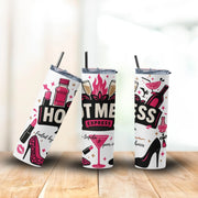 Three tumblers with colorful designs on a wooden surface.