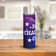 Purple tumbler with stars and text on a wooden surface with a blurred kitchen background