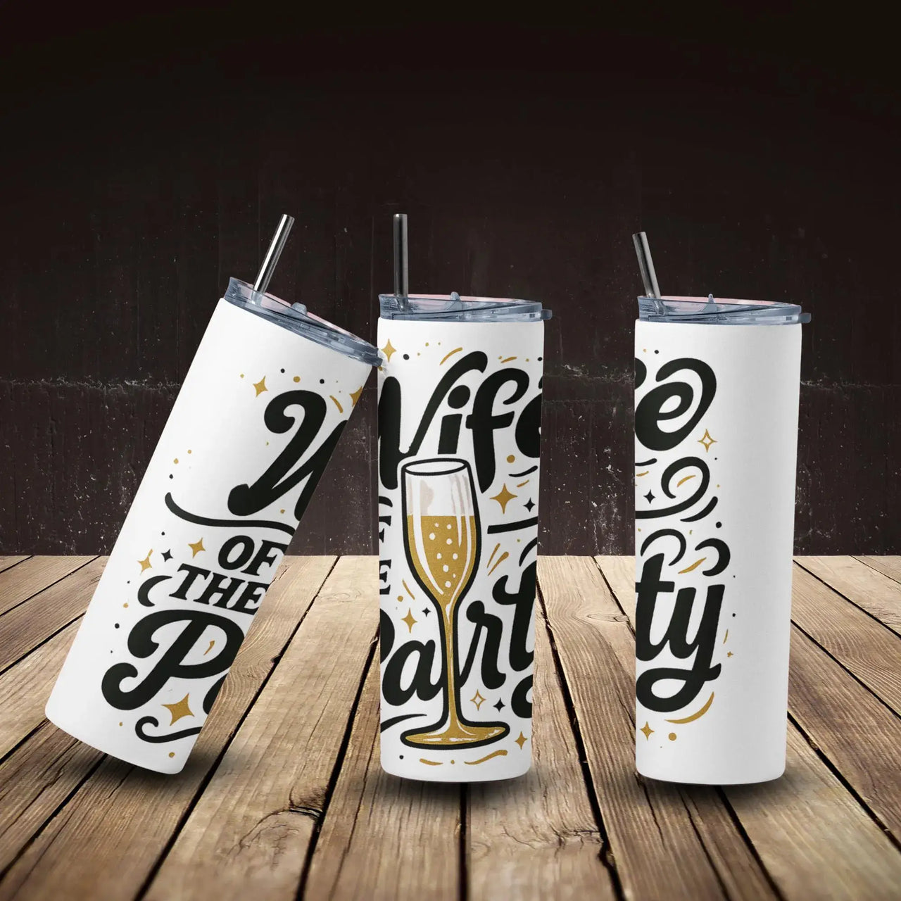 Three white tumblers with black and gold text on a wooden surface and dark background