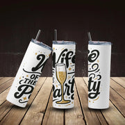 Three white tumblers with black and gold text on a wooden surface and dark background