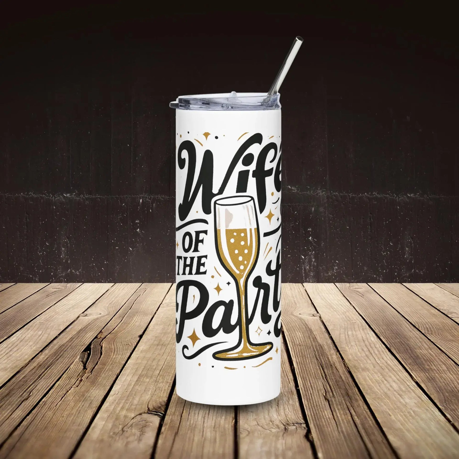 Tumbler with 'Wife of the Party' text and champagne glass design on a wooden surface.