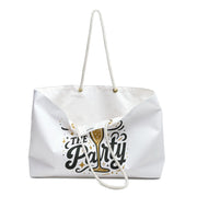 White tote bag with 'The Party' text and champagne glass design on a white background