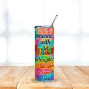 Tumbler with motivational quote on a colorful background