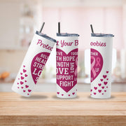 Three tumblers with pink and white designs on a wooden surface.