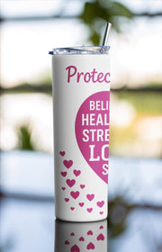 Tumbler with motivational phrases and heart designs on a blurred natural background