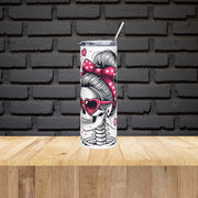 Tumbler with skull and bun design on a wooden surface with black brick wall background