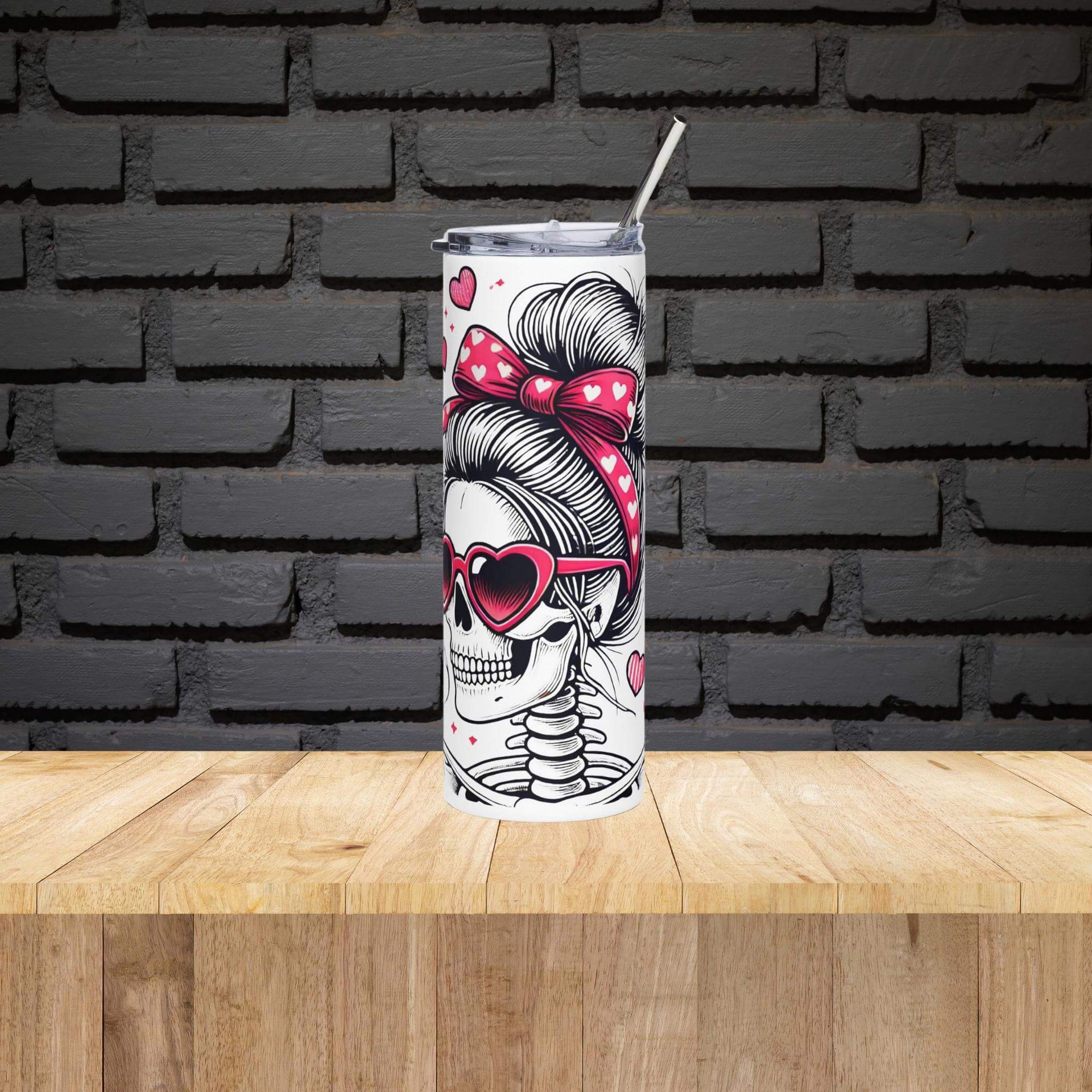 Tumbler with skull and bun design on a wooden surface with black brick wall background
