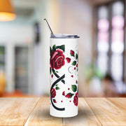 Tumbler with red rose design on a wooden table